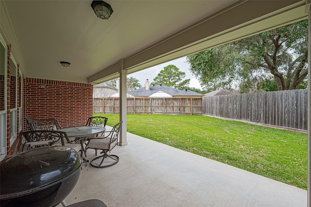 view of patio with a fenced backyard and outdoor dining space