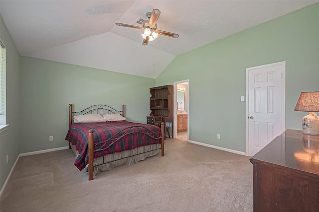 bedroom featuring ensuite bath, carpet, baseboards, and vaulted ceiling