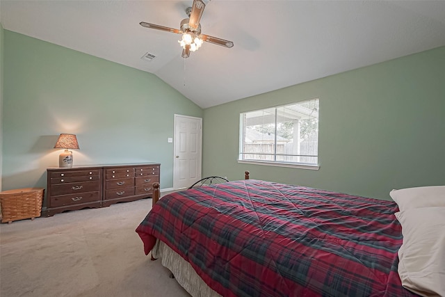 bedroom with lofted ceiling, light carpet, visible vents, and a ceiling fan