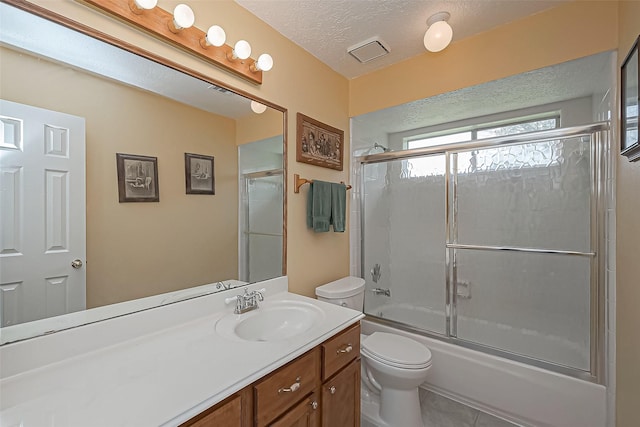 full bath featuring shower / bath combination with glass door, visible vents, toilet, a textured ceiling, and vanity