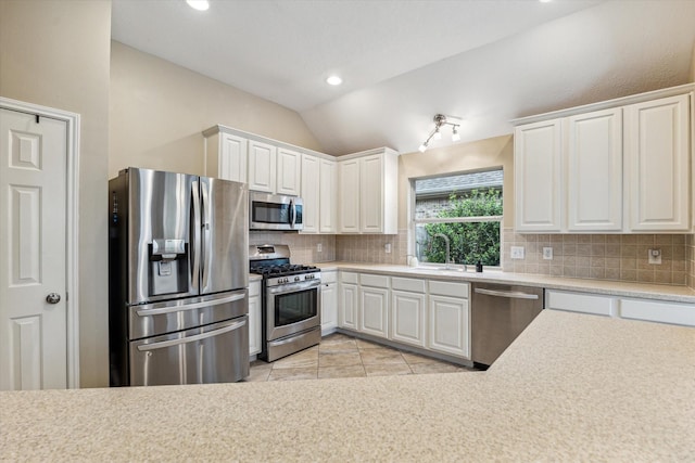 kitchen with white cabinetry, light countertops, tasteful backsplash, and appliances with stainless steel finishes