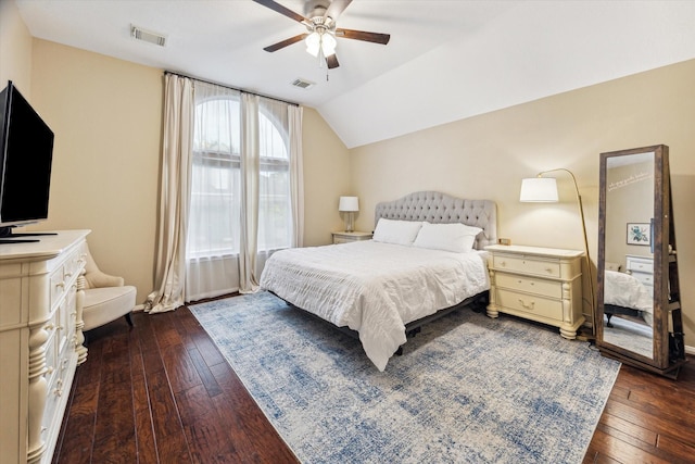 bedroom with visible vents, lofted ceiling, and dark wood-style floors