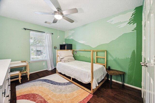 bedroom with visible vents, wood finished floors, baseboards, ceiling fan, and vaulted ceiling