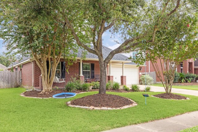 view of front of property featuring brick siding, concrete driveway, a front lawn, and fence