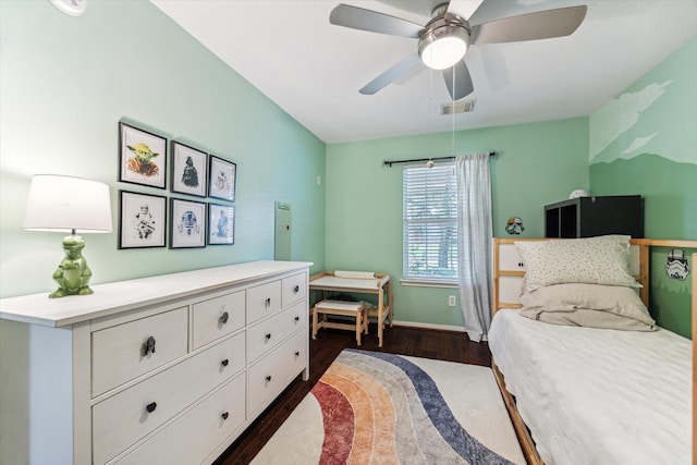 bedroom featuring visible vents, baseboards, dark wood finished floors, and a ceiling fan