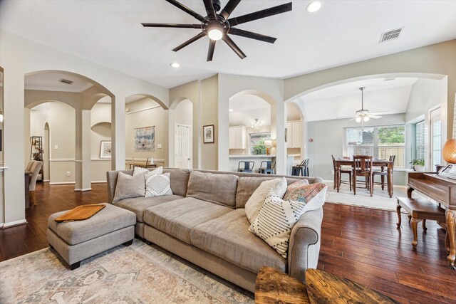 living area with visible vents, a ceiling fan, recessed lighting, wood-type flooring, and vaulted ceiling