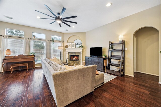 living room featuring recessed lighting, a fireplace, dark wood-type flooring, and a ceiling fan