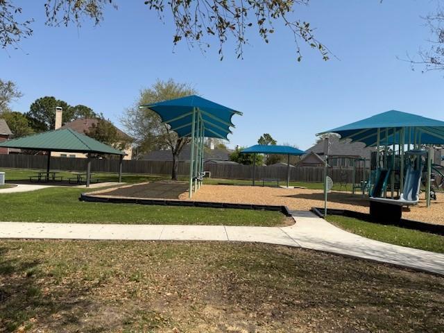 community play area featuring a gazebo and fence