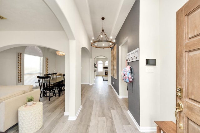 interior space featuring an inviting chandelier, visible vents, baseboards, and light wood finished floors