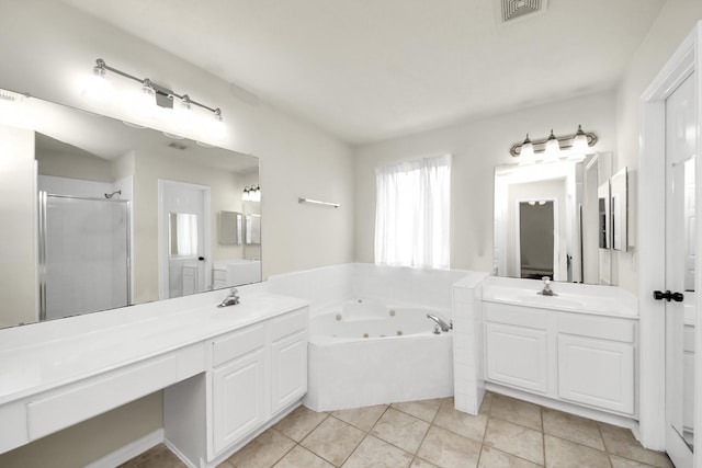 full bath featuring a whirlpool tub, a sink, visible vents, and tile patterned floors