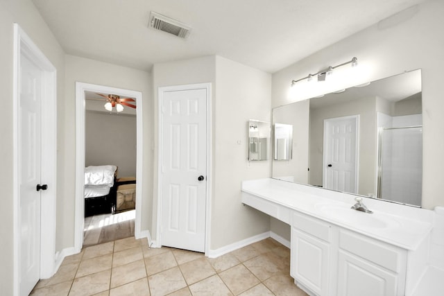 bathroom featuring baseboards, visible vents, a shower with shower door, tile patterned floors, and vanity