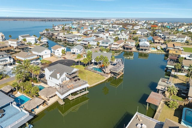 drone / aerial view with a water view and a residential view