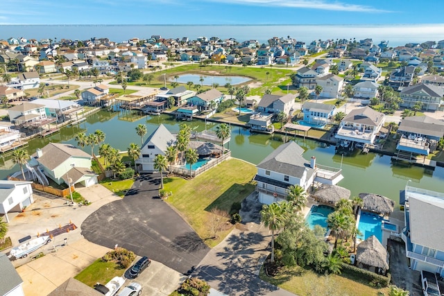 bird's eye view featuring a water view and a residential view