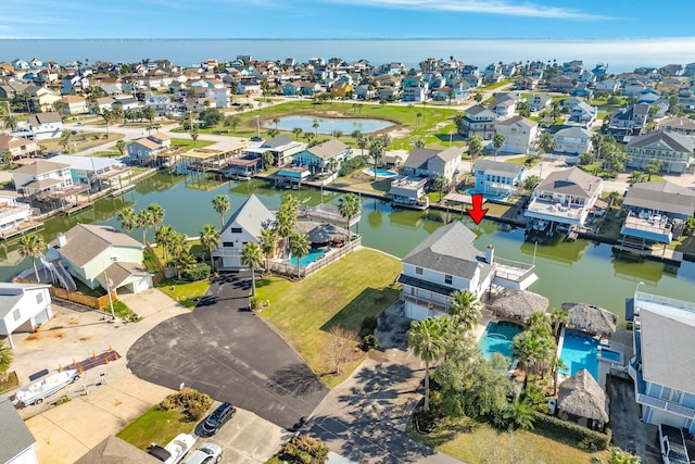 bird's eye view with a water view and a residential view