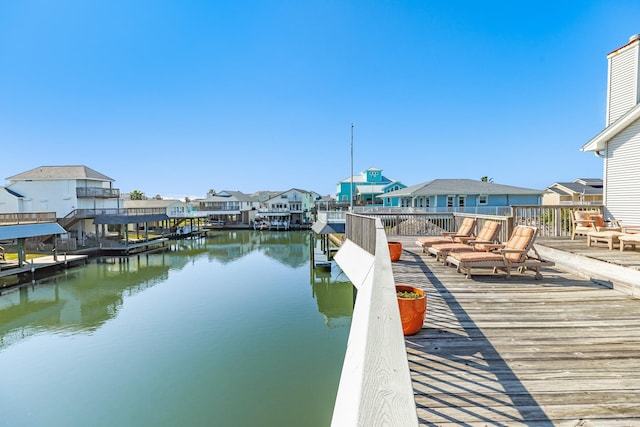 dock area featuring a water view and a residential view