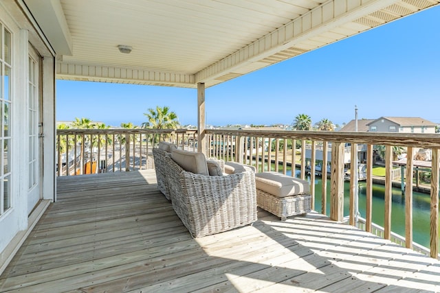 wooden terrace featuring a water view