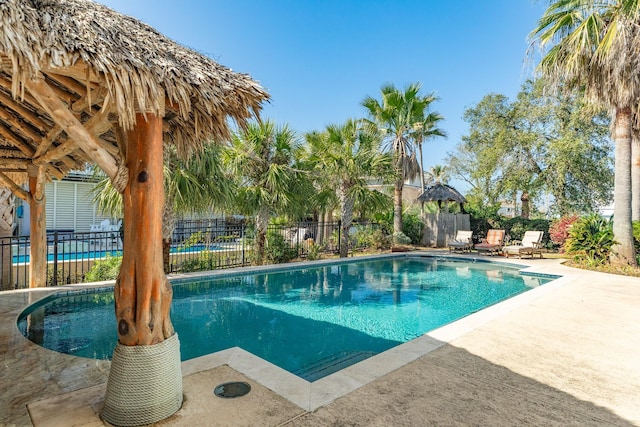 view of swimming pool featuring a fenced in pool, a patio, and fence