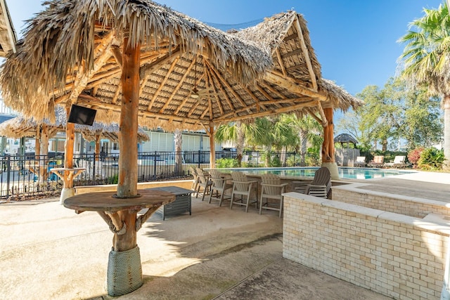 surrounding community with a gazebo, fence, a pool, and a patio