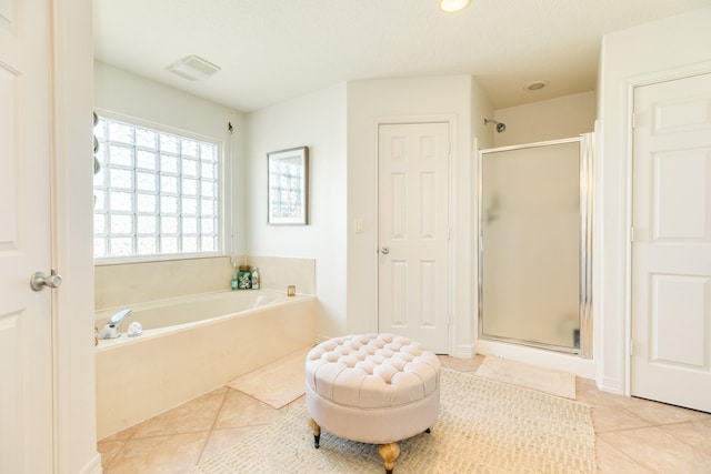 full bath featuring a stall shower, visible vents, a bath, and tile patterned floors