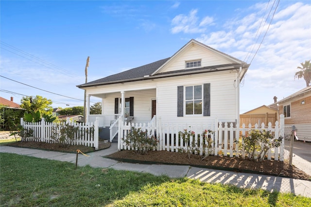 view of front of home featuring a porch and a fenced front yard