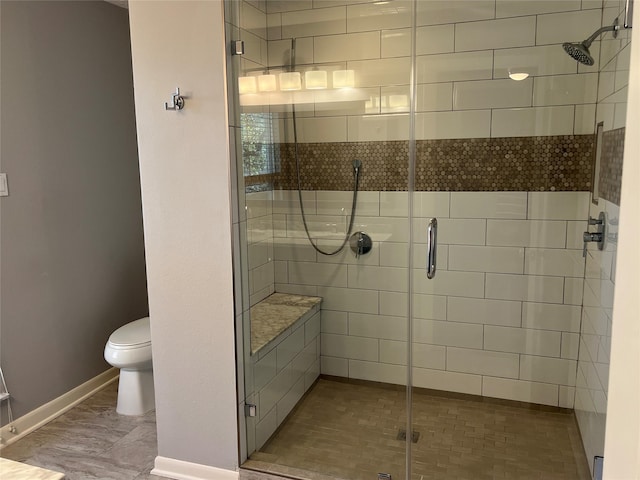 full bath with a stall shower, baseboards, and toilet