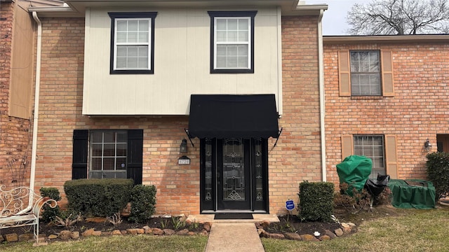 view of front of house featuring brick siding