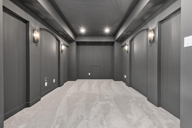 carpeted cinema with baseboards, arched walkways, a tray ceiling, and recessed lighting