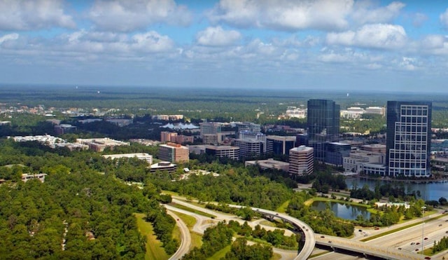 birds eye view of property featuring a water view and a city view