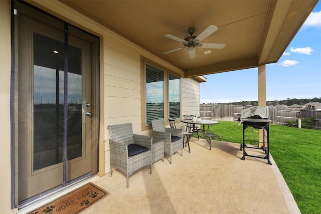 view of patio featuring ceiling fan, grilling area, and fence