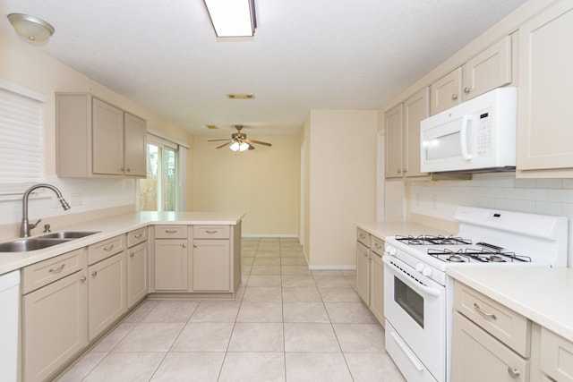 kitchen with white appliances, ceiling fan, a peninsula, light countertops, and a sink