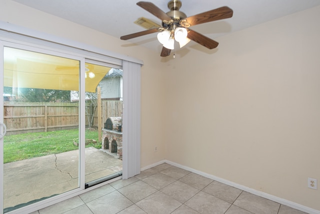 unfurnished room featuring light tile patterned flooring, ceiling fan, and baseboards