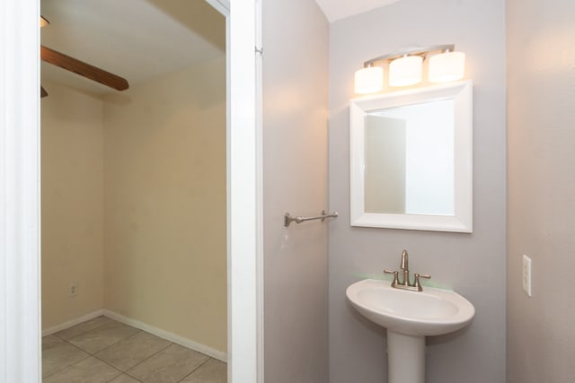 bathroom with baseboards, a sink, and tile patterned floors