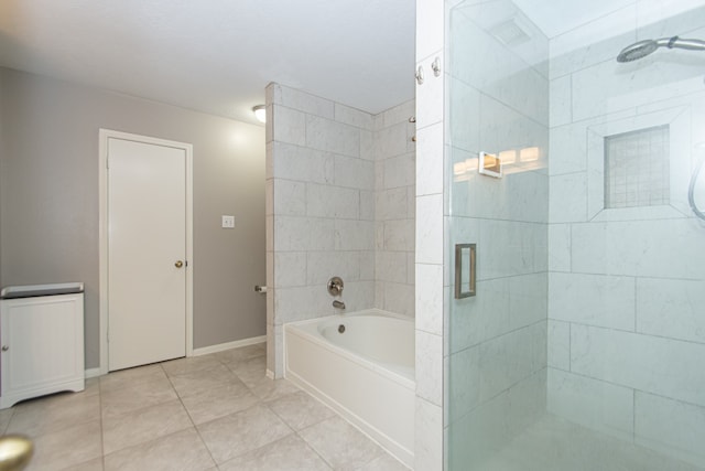 full bathroom with a garden tub, a shower stall, baseboards, and tile patterned flooring