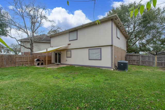 rear view of property with a lawn, a patio, a fenced backyard, central air condition unit, and brick siding