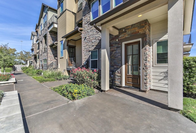 doorway to property featuring stone siding