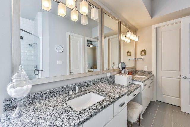 full bath featuring ceiling fan, a shower stall, vanity, and tile patterned floors