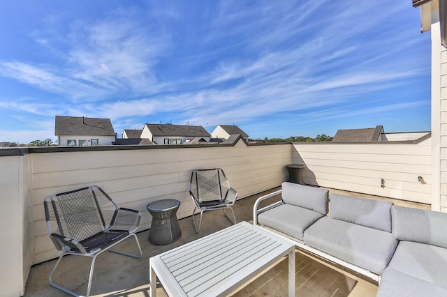 view of patio with an outdoor living space and a balcony