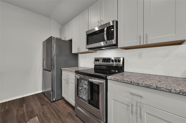 kitchen featuring tasteful backsplash, baseboards, dark wood-style floors, light stone counters, and stainless steel appliances