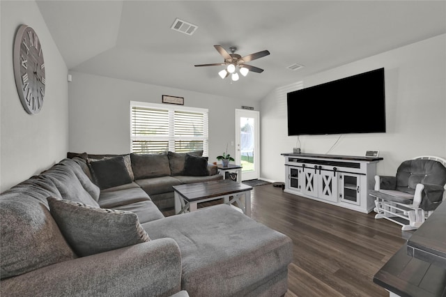 living area featuring dark wood-type flooring, visible vents, vaulted ceiling, and a ceiling fan