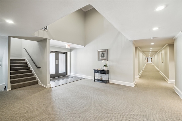 unfurnished living room with recessed lighting, carpet flooring, baseboards, and stairs