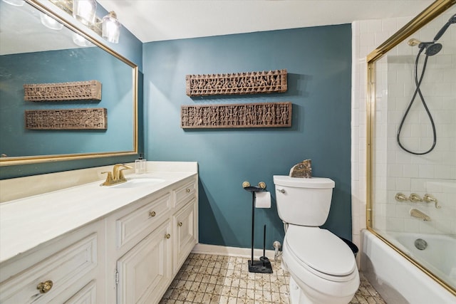 bathroom with combined bath / shower with glass door, vanity, toilet, and baseboards