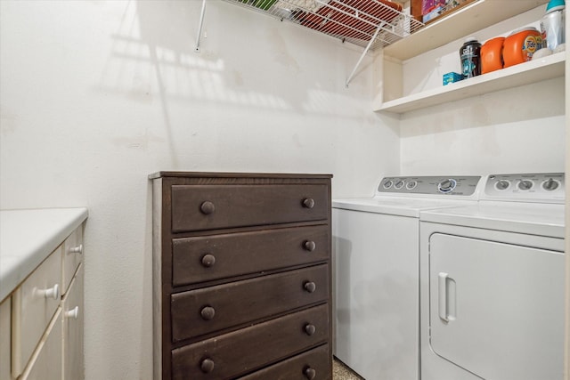 washroom featuring cabinet space and independent washer and dryer