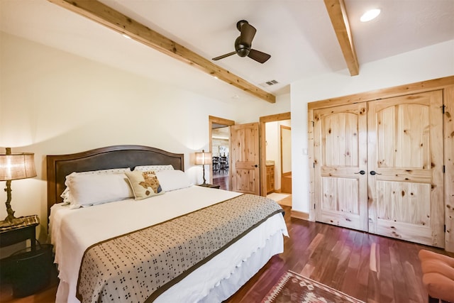 bedroom featuring ceiling fan, connected bathroom, dark wood-style flooring, visible vents, and beam ceiling