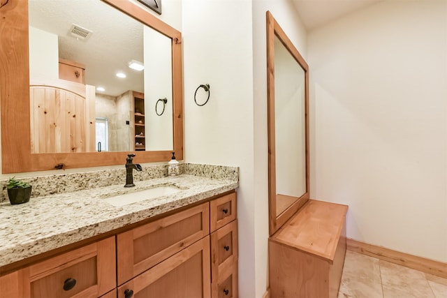 bathroom featuring tile patterned flooring, vanity, and visible vents