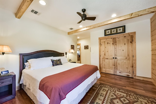 bedroom featuring beamed ceiling, wood finished floors, and visible vents