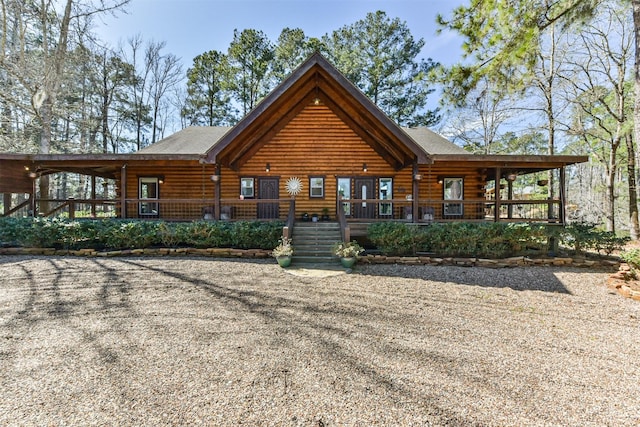 rear view of house featuring a porch