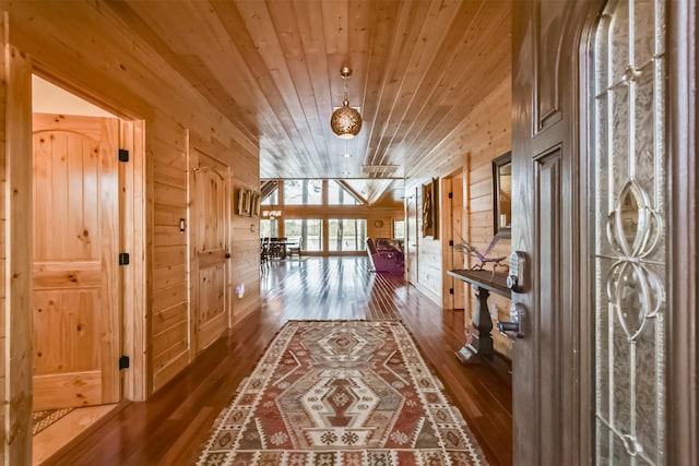 corridor with wood walls, wood ceiling, and hardwood / wood-style flooring