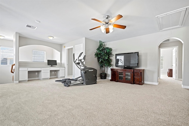 exercise room with attic access, carpet flooring, visible vents, and baseboards