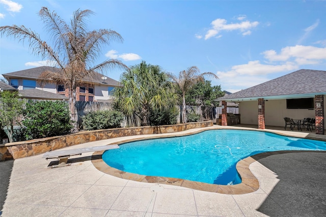 view of swimming pool featuring a diving board, a patio, a fenced backyard, and a fenced in pool