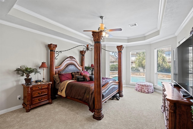 bedroom featuring visible vents, a tray ceiling, ornamental molding, and light colored carpet